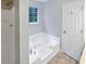 Bright bathroom featuring a soaking tub, separate shower, and a window for natural light at 5723 Antelope Trl, Atlanta, GA 30349