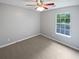 Well-lit bedroom featuring neutral walls, ceiling fan, and a window providing natural light at 5723 Antelope Trl, Atlanta, GA 30349