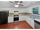 Bright kitchen with white cabinets, stainless steel appliances, and hardwood floors at 5723 Antelope Trl, Atlanta, GA 30349