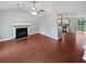 Open living room with hardwood flooring, a fireplace, and easy access to the kitchen at 5723 Antelope Trl, Atlanta, GA 30349