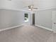 Spacious main bedroom featuring carpet, ceiling fan, and an ensuite bathroom entrance at 5723 Antelope Trl, Atlanta, GA 30349
