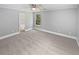 Large carpeted main bedroom with a ceiling fan, window, and bathroom access at 5723 Antelope Trl, Atlanta, GA 30349