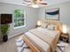 Cozy bedroom with soft carpet, a ceiling fan, and a picture window with tree views at 5723 Antelope Trl, Atlanta, GA 30349
