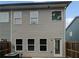 Backyard featuring the exterior of a townhouse with an AC unit and a wooden fence at 3513 Lakeview Crk, Lithonia, GA 30038