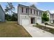 Charming townhouse featuring a two-car garage with a well-manicured lawn at 3513 Lakeview Crk, Lithonia, GA 30038