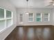 Living room featuring hardwood floors, large windows, and a door to the backyard at 3513 Lakeview Crk, Lithonia, GA 30038