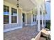 Spacious covered porch with brick flooring and light fixtures at 330 Cavin Dr, Roswell, GA 30076