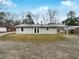 Exterior rear view of the home showing a large lot with a backyard and gravel area at 118 Mann Blvd, Stockbridge, GA 30281