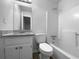 Well-lit bathroom with granite countertops, a tub shower, and modern fixtures at 118 Mann Blvd, Stockbridge, GA 30281