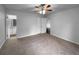 Bedroom featuring a ceiling fan, carpet, and access to a bathroom at 118 Mann Blvd, Stockbridge, GA 30281