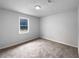 Empty bedroom featuring carpeted floors, a window, and a ceiling light at 118 Mann Blvd, Stockbridge, GA 30281