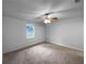 Empty bedroom featuring carpeted floors, a ceiling fan, and a window at 118 Mann Blvd, Stockbridge, GA 30281