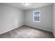 Neutral bedroom with carpet, a window, and simple design at 118 Mann Blvd, Stockbridge, GA 30281