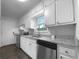 Well-lit kitchen with granite countertops, stainless steel appliances, and white cabinetry at 118 Mann Blvd, Stockbridge, GA 30281