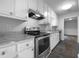 Modern kitchen with white cabinets, stainless steel appliances, and stone countertops at 118 Mann Blvd, Stockbridge, GA 30281
