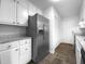 Kitchen featuring stainless steel refrigerator, white cabinets, and stone countertops at 118 Mann Blvd, Stockbridge, GA 30281