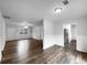 Open-concept living room with hardwood floors, fireplace, and access to kitchen and front door at 118 Mann Blvd, Stockbridge, GA 30281