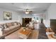 Cozy living room featuring a stone fireplace and hardwood floors at 118 Mann Blvd, Stockbridge, GA 30281