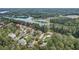 Picturesque aerial view showcasing waterfront homes nestled among lush greenery and the lake at 6219 Woodlake Dr, Buford, GA 30518