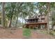 Large home with covered patios, multiple levels, and wooded views in backyard at 6219 Woodlake Dr, Buford, GA 30518