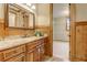 Bathroom view with wood paneled wall, granite vanity, sink, mirror, and walk-in closet at 6219 Woodlake Dr, Buford, GA 30518