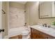 Bathroom featuring tiled shower and wood vanity with marble countertop at 6219 Woodlake Dr, Buford, GA 30518