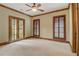 Bedroom with wood trim, plantation shutters and French doors to the outside at 6219 Woodlake Dr, Buford, GA 30518