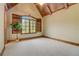 Bedroom with carpet, wood trim, shutters, vaulted wood ceiling and decorative tree at 6219 Woodlake Dr, Buford, GA 30518