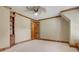 Bedroom with carpet, wood trim, bookshelves, wood door and decorative ceiling fan at 6219 Woodlake Dr, Buford, GA 30518