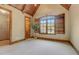 Bedroom with vaulted wood ceiling, shutters, and wood trim, and closet with shelves at 6219 Woodlake Dr, Buford, GA 30518