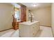 Spacious walk-in closet boasts a custom island with drawers and unique rustic wood doors at 6219 Woodlake Dr, Buford, GA 30518