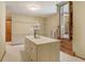 Walk-in closet with a custom island featuring drawers, shelving and rustic door access at 6219 Woodlake Dr, Buford, GA 30518