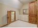 Walk-in closet boasts a custom island with drawers and unique rustic wood doors at 6219 Woodlake Dr, Buford, GA 30518