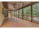 Spacious covered patio features wood flooring, ceiling fans, and outdoor living space at 6219 Woodlake Dr, Buford, GA 30518