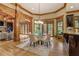 Formal dining room with wood beam arches and views into the living room and gourmet kitchen at 6219 Woodlake Dr, Buford, GA 30518