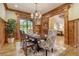 Elegant dining room showcasing wood trim, a decorative chandelier, and hardwood flooring at 6219 Woodlake Dr, Buford, GA 30518