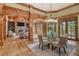 Open-concept dining area with wood beam arches and views into the living room at 6219 Woodlake Dr, Buford, GA 30518
