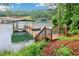 Backyard features a private dock with boat lift on a picturesque lake setting at 6219 Woodlake Dr, Buford, GA 30518