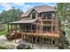 Multi-level home exterior with brick and stone accents with outdoor patios at 6219 Woodlake Dr, Buford, GA 30518
