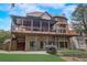 Multi-level patio home featuring stone and brick exterior and lawn at 6219 Woodlake Dr, Buford, GA 30518