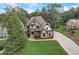 Beautiful brick home featuring a manicured lawn and long driveway for ample parking at 6219 Woodlake Dr, Buford, GA 30518