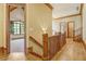 Hallway with hardwood floors, decorative lighting, and wood trim at 6219 Woodlake Dr, Buford, GA 30518