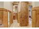 Hallway with wood trim, a view of the bathroom, and a bedroom at 6219 Woodlake Dr, Buford, GA 30518