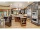 Gourmet kitchen featuring stainless steel appliances, custom cabinetry, and a granite island at 6219 Woodlake Dr, Buford, GA 30518