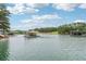 Wide shot of a picturesque lake dotted with boat docks and surrounded by lush greenery and clear blue skies at 6219 Woodlake Dr, Buford, GA 30518