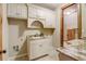 Functional laundry room with granite counters, custom cabinets and rustic wooden door access at 6219 Woodlake Dr, Buford, GA 30518