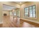 Open living space with fireplace, hardwood floors, and scenic outdoor views at 6219 Woodlake Dr, Buford, GA 30518