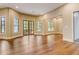 Bright living area with hardwood floors, many windows and French doors at 6219 Woodlake Dr, Buford, GA 30518