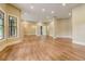 Open-concept living space with hardwood floors and multiple windows at 6219 Woodlake Dr, Buford, GA 30518