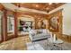 Spacious living room with wood-beam ceilings, arched doorways, and abundant natural light at 6219 Woodlake Dr, Buford, GA 30518